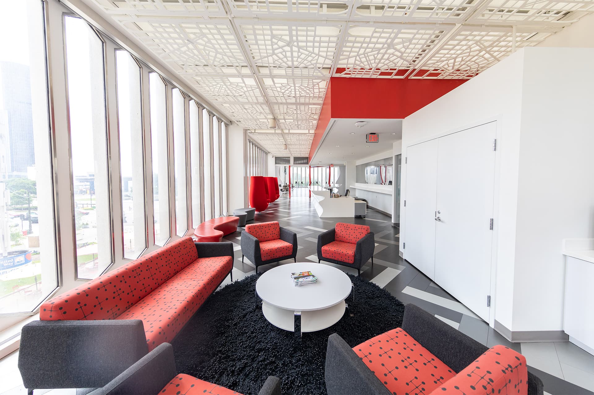 Lobby space to The Beacon event space located on the second floor set with a couch, arm chairs and coffee table.