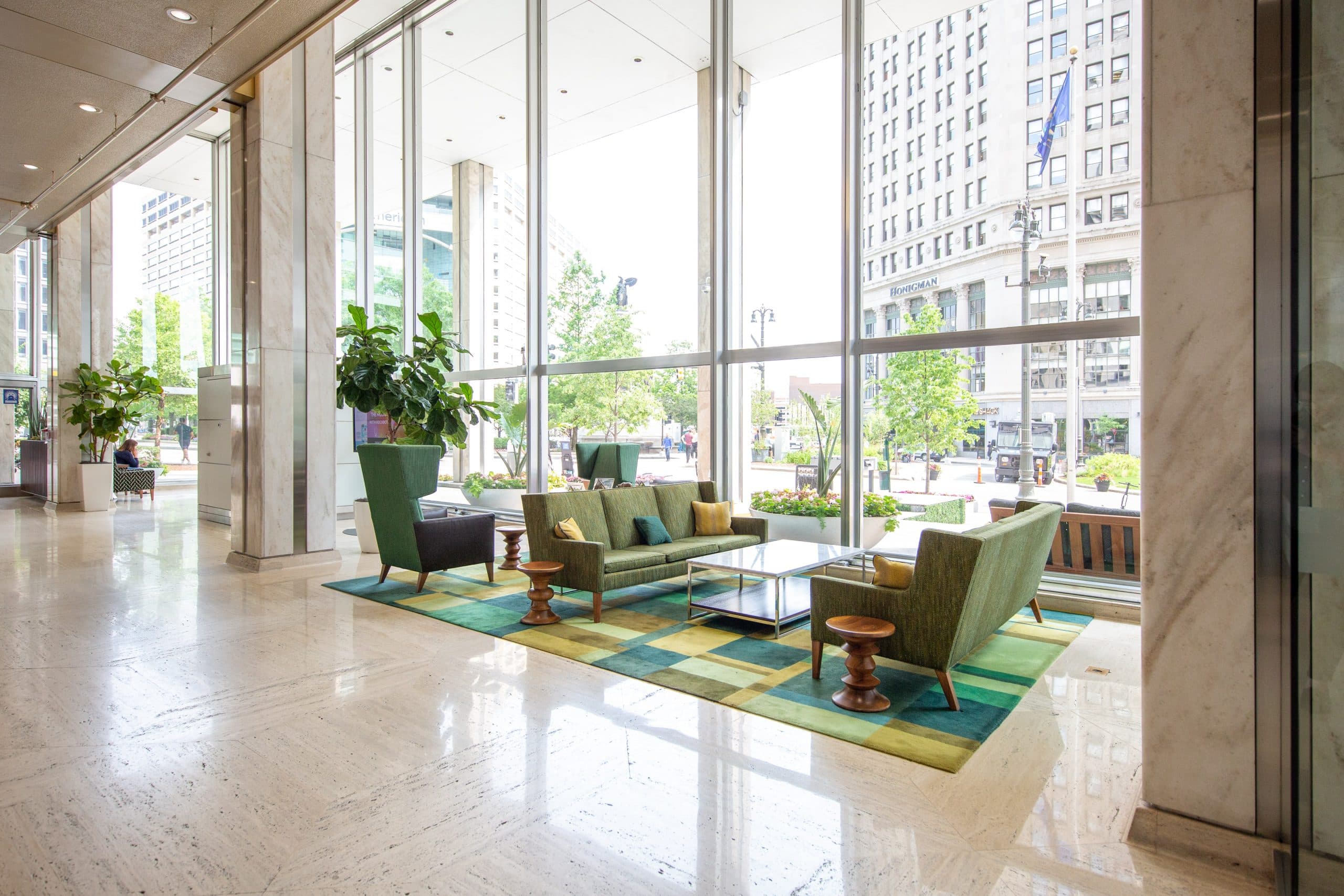 Chase Tower Lobby with a sophisticated design, featuring tall columns, polished floors, and a mix of natural and artificial lighting.